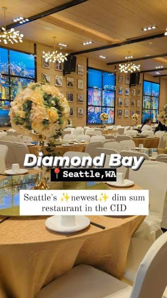 Inside Diamond Bay Restaurant in Seattle's Chinatown–International District — round banquet tables with gold tablecloths and white chair covers under chandeliers